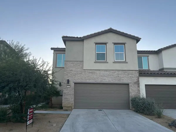 a front view of a house with yard