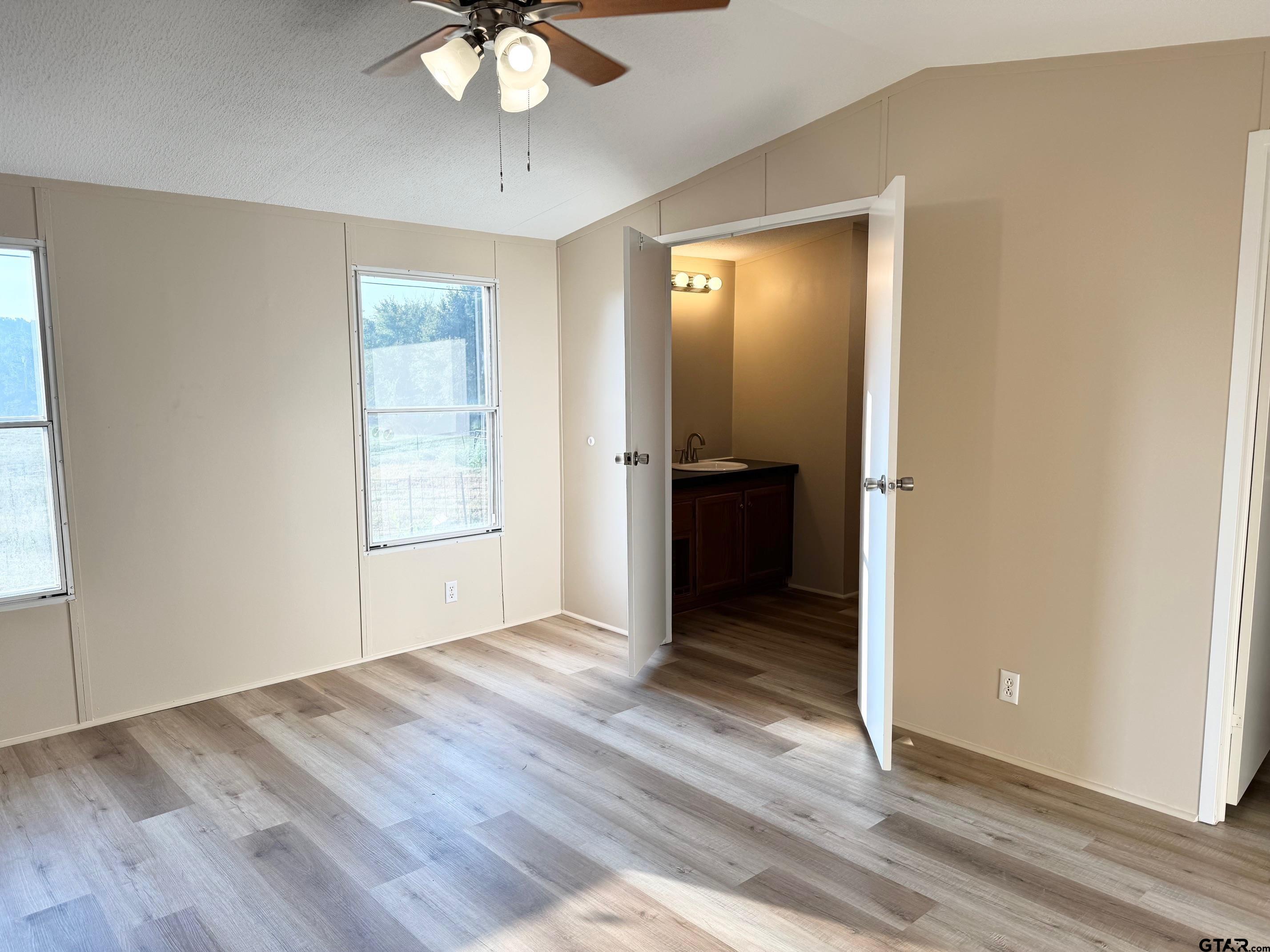 427 Old Latexo Road Grapeland, TX 75844 - Photo 11 of 18 wooden floor in an empty room with a window