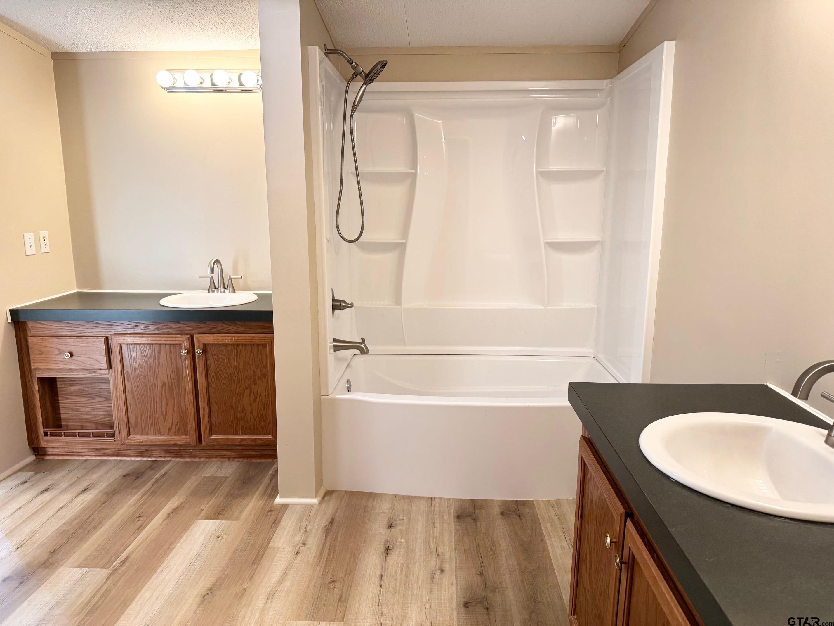 427 Old Latexo Road Grapeland, TX 75844 - Photo 14 of 18 a bathroom with a sink vanity granite tub shower and a mirror