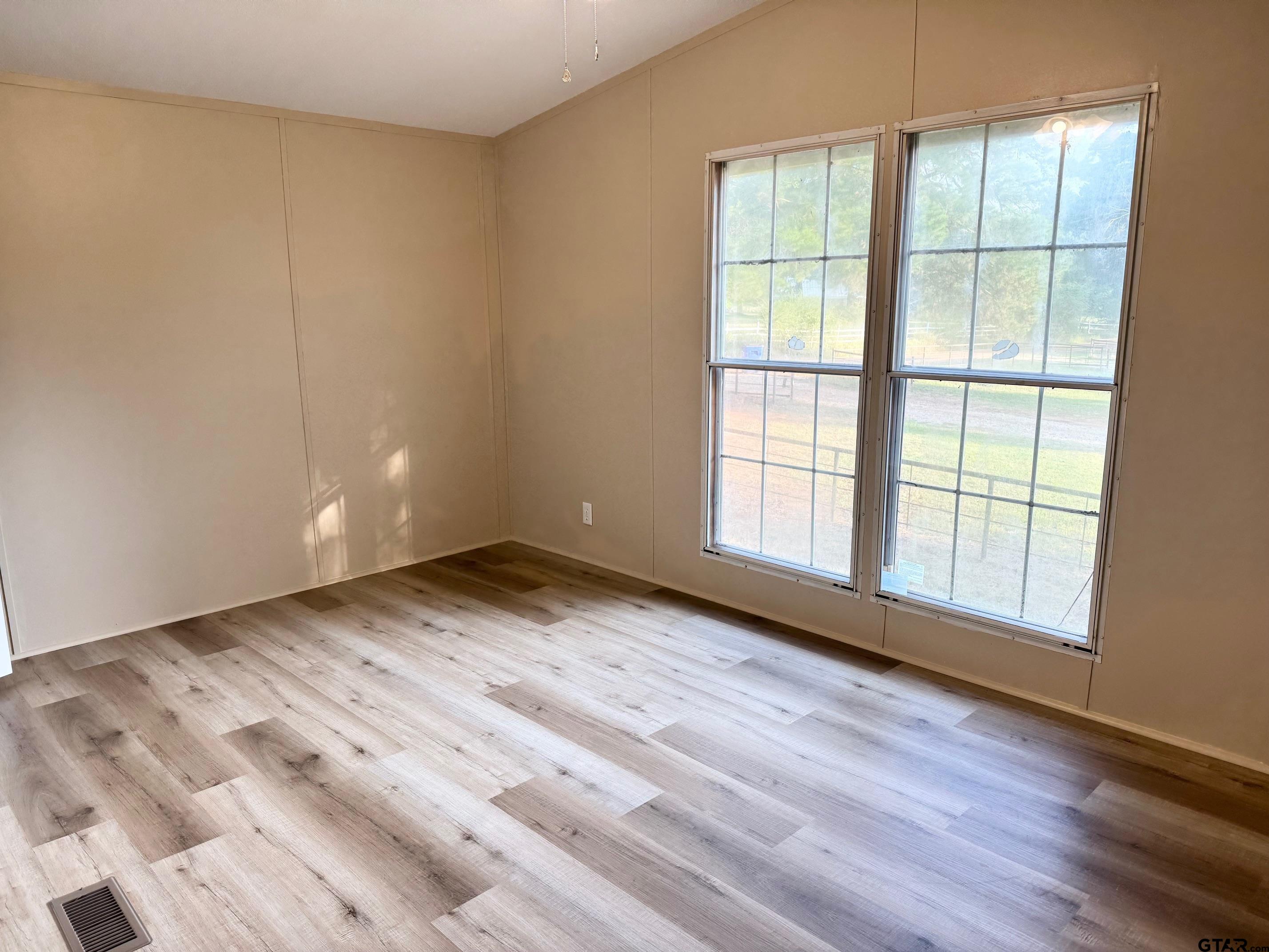 427 Old Latexo Road Grapeland, TX 75844 - Photo 16 of 18 a view of empty room with wooden floor and fan