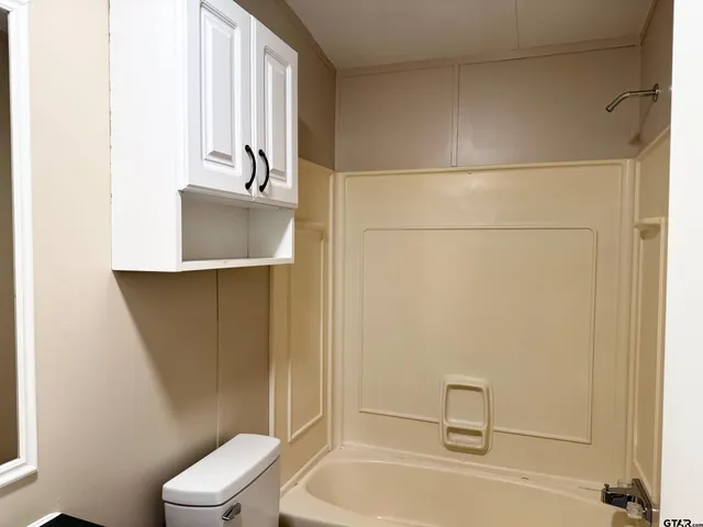 a bathroom with a bathtub a toilet and a sink
