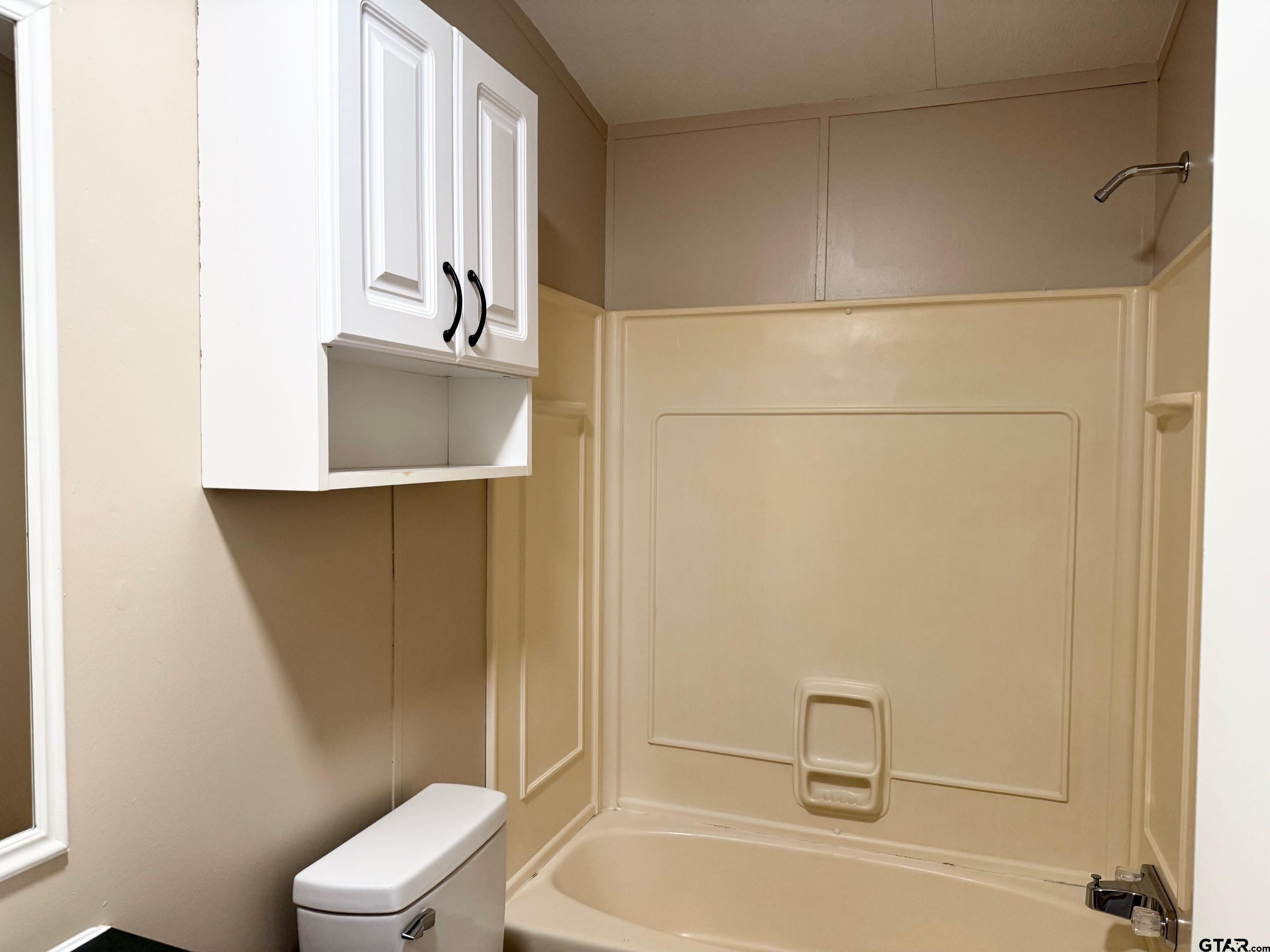 427 Old Latexo Road Grapeland, TX 75844 - Photo 17 of 18 a bathroom with a bathtub a toilet and a sink