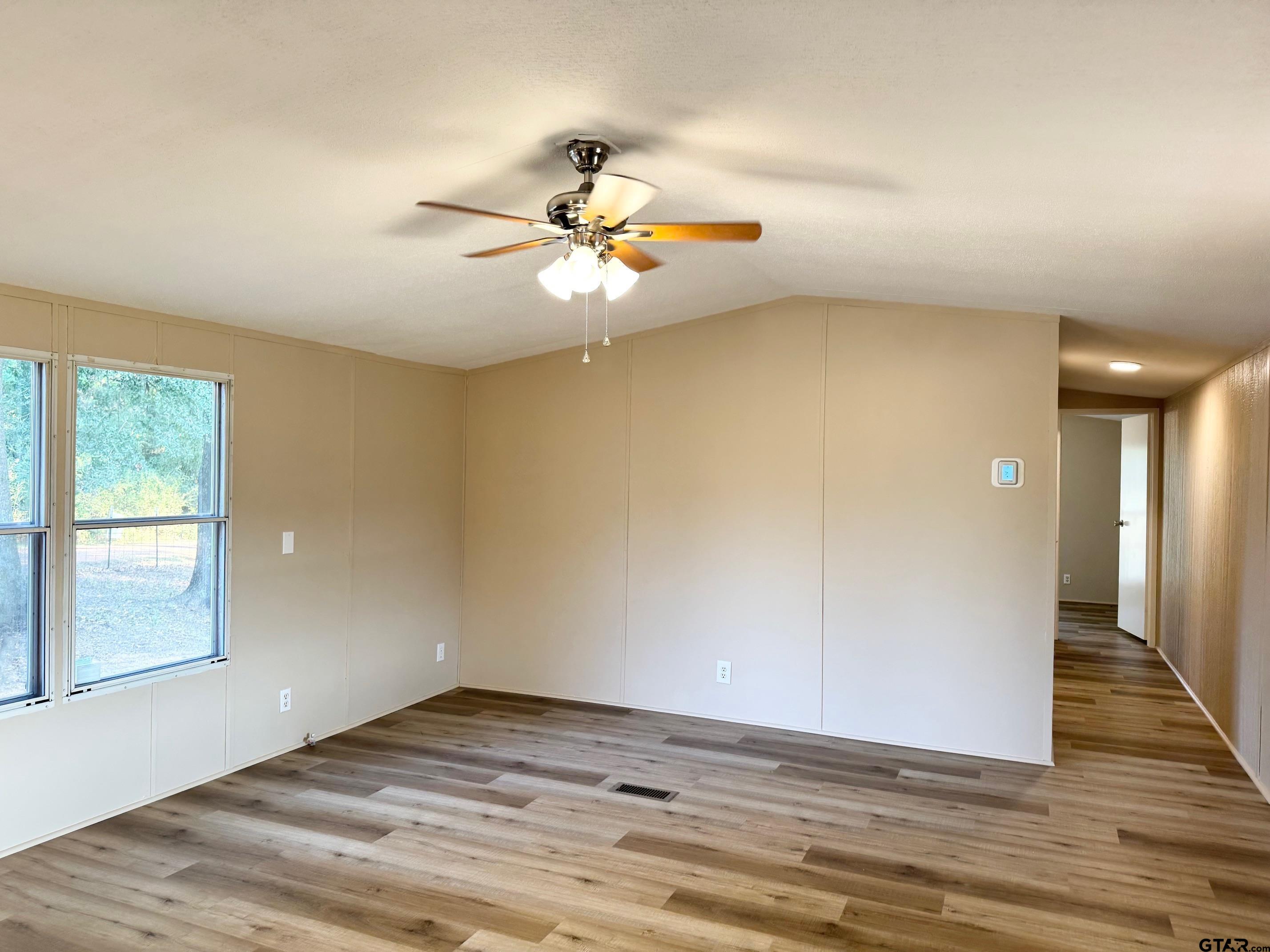 427 Old Latexo Road Grapeland, TX 75844 - Photo 4 of 18 a view of empty room with wooden floor and fan