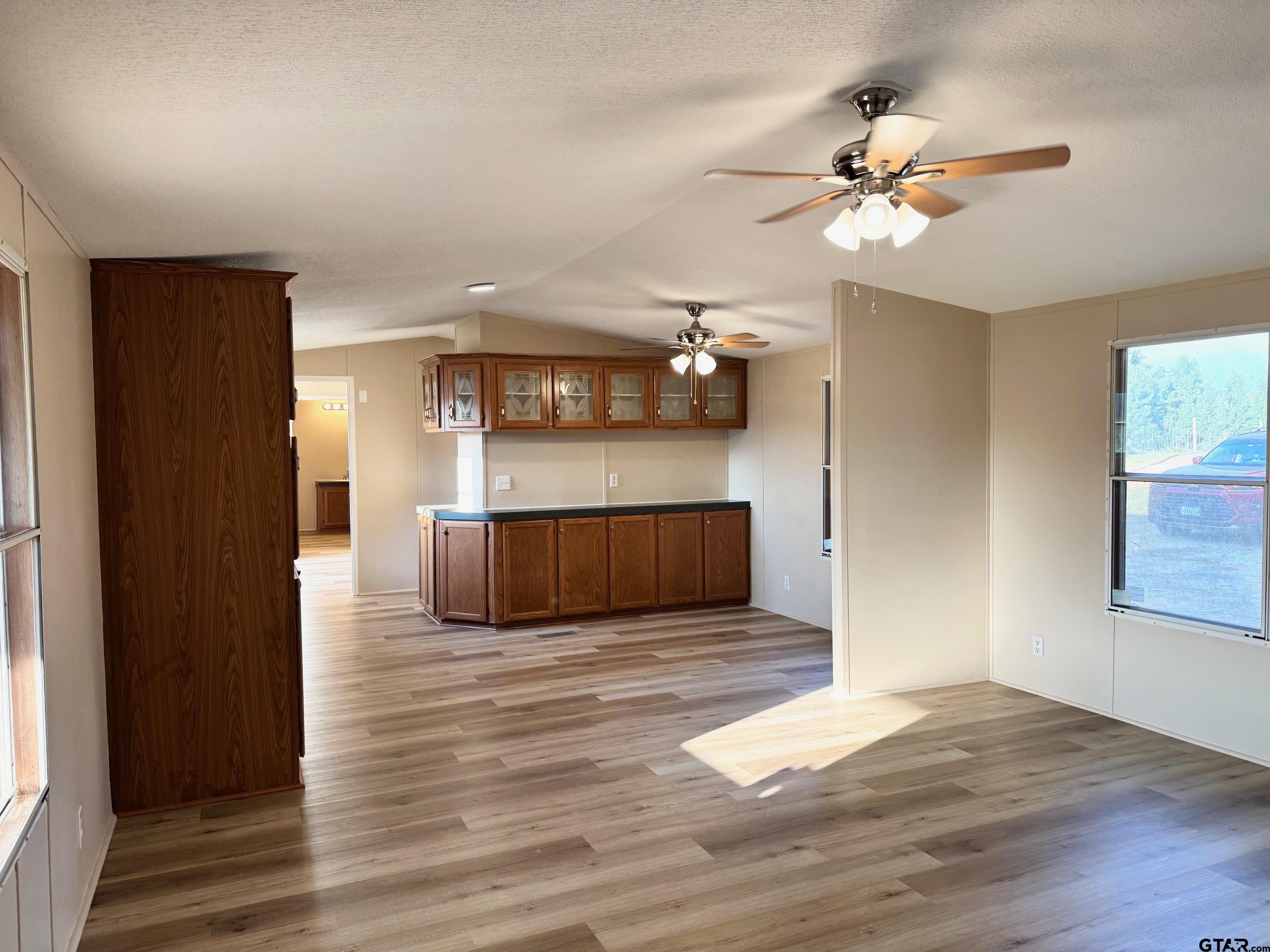 427 Old Latexo Road Grapeland, TX 75844 - Photo 6 of 18 a view of a kitchen with a sink and cabinet wooden floor chandelier