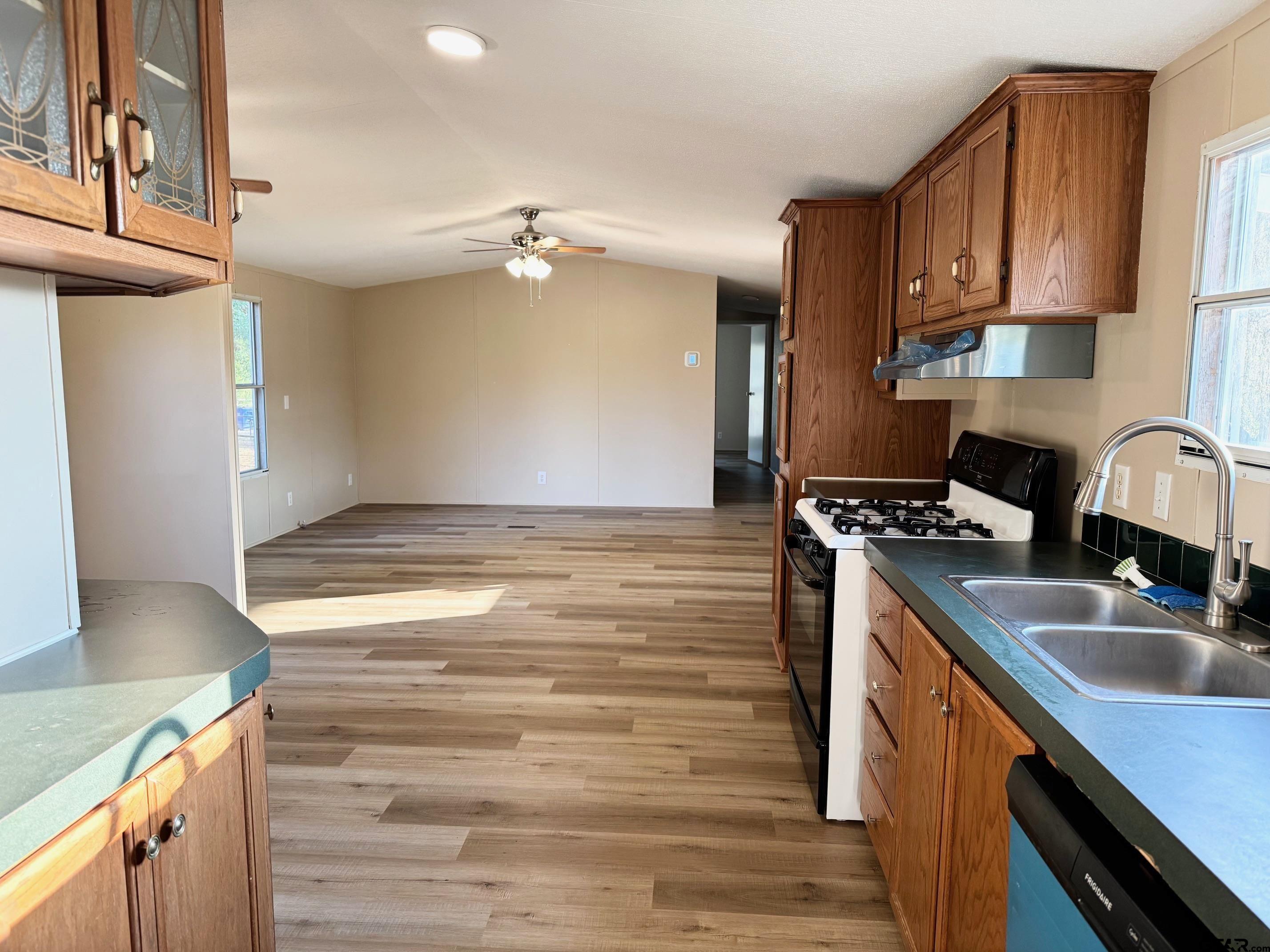 427 Old Latexo Road Grapeland, TX 75844 - Photo 8 of 18 a kitchen with kitchen island granite countertop a sink appliances cabinets and counter space