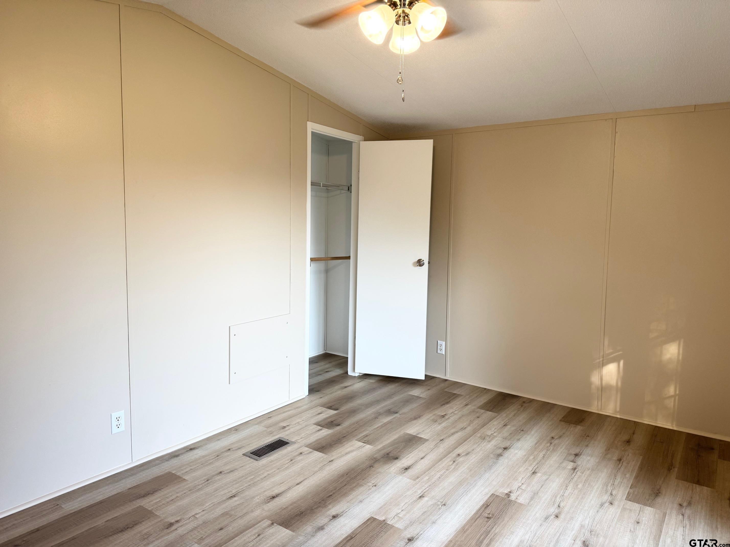427 Old Latexo Road Grapeland, TX 75844 - Photo 10 of 18 wooden floor in an empty room with a window