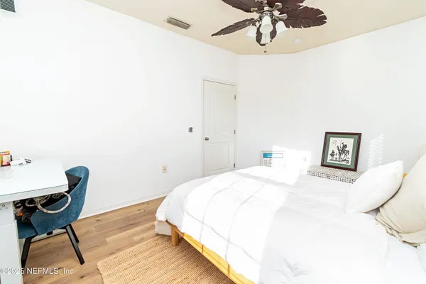 a bedroom with a bed and chair