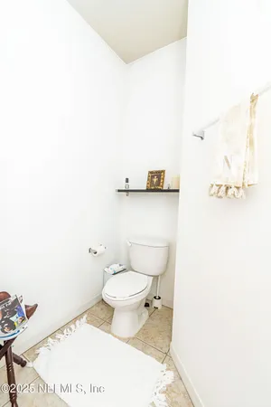a bathroom with a toilet and a mirror