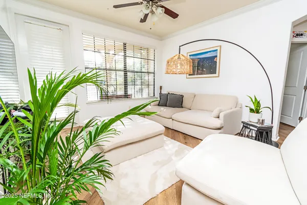 a living room with furniture and a potted plant