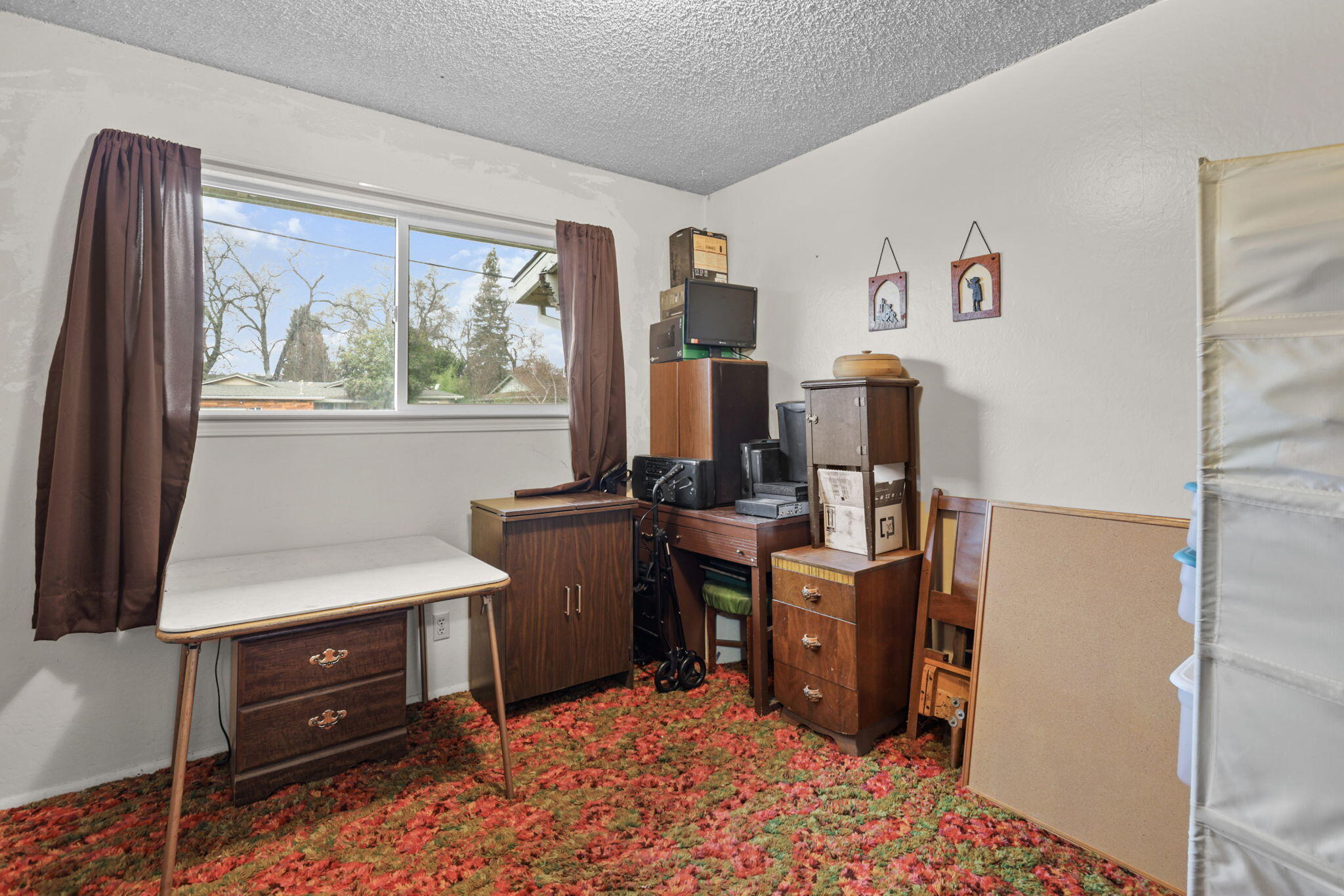 6725 Reflection Street Redding, CA 96001 - Photo 12 of 20 a view of a workspace with furniture and a window