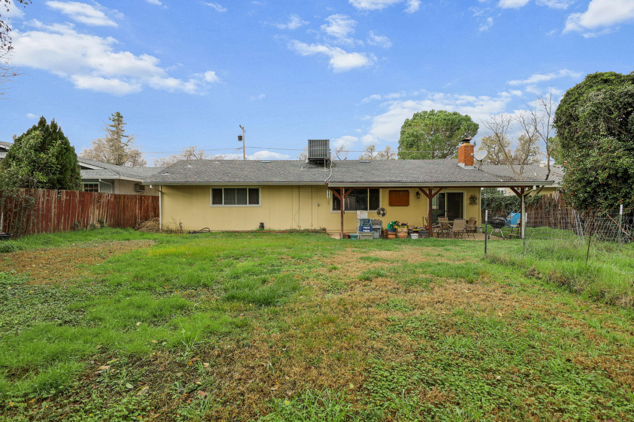 6725 Reflection Street Redding, CA 96001 - Photo 15 of 20 a view of a house with a backyard