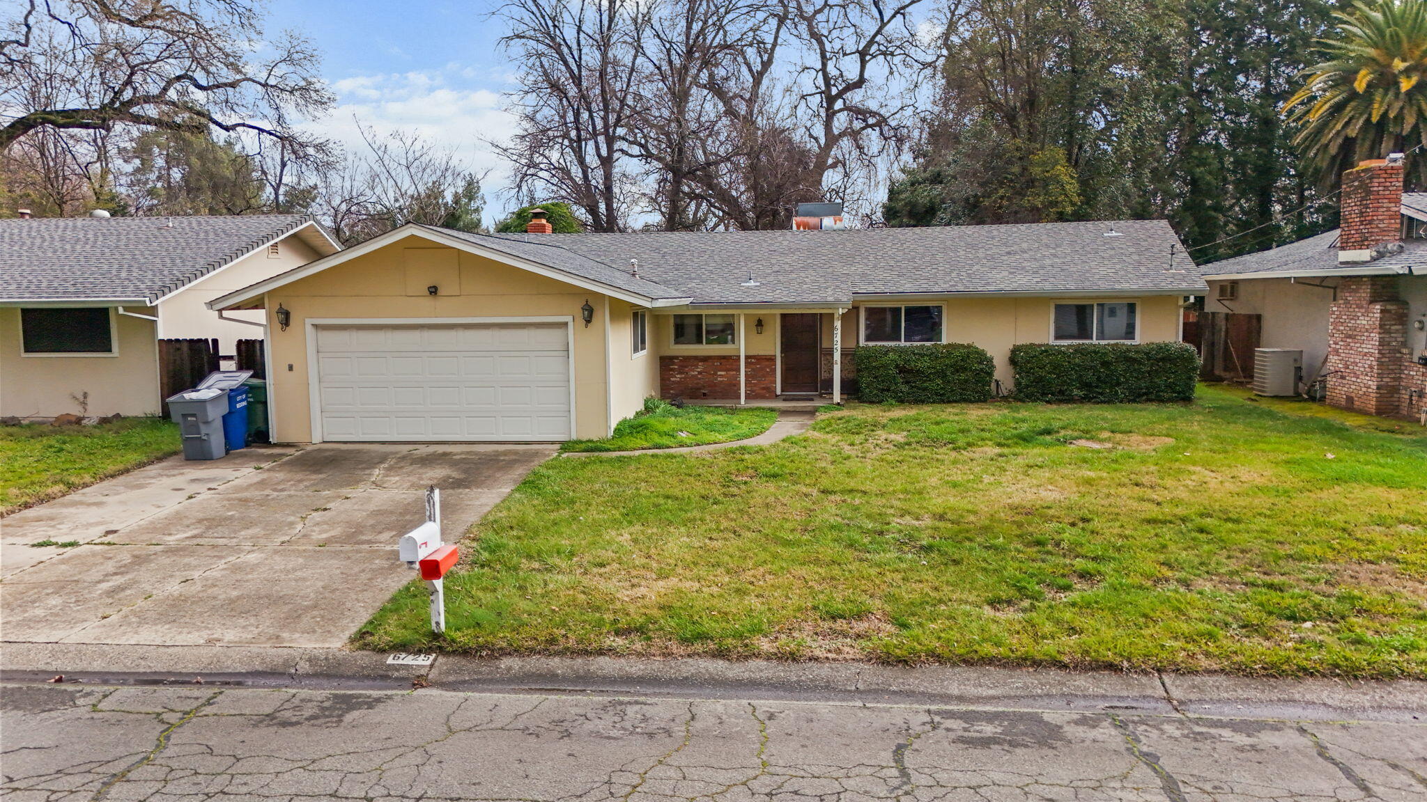 6725 Reflection Street Redding, CA 96001 - Photo 18 of 20 a front view of a house with a yard and garage