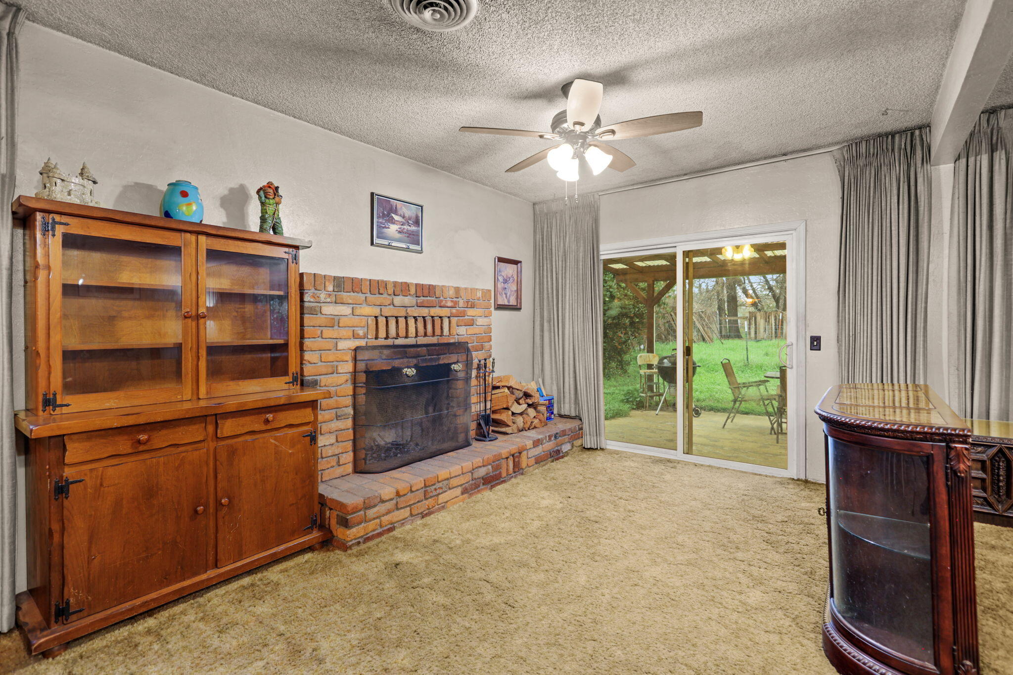 6725 Reflection Street Redding, CA 96001 - Photo 4 of 20 a living room with furniture and a fireplace