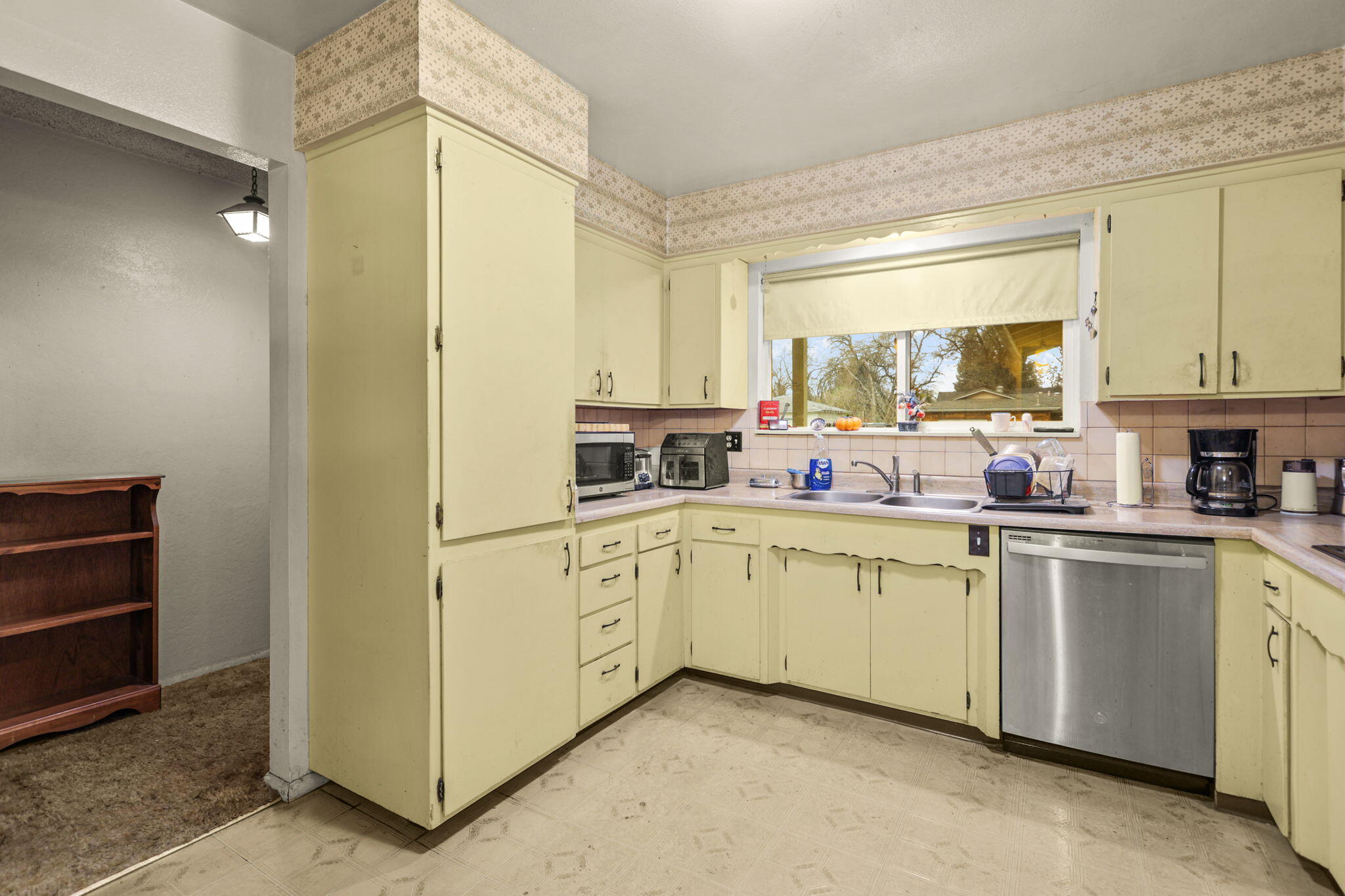 6725 Reflection Street Redding, CA 96001 - Photo 7 of 20 a kitchen with cabinets appliances and a window