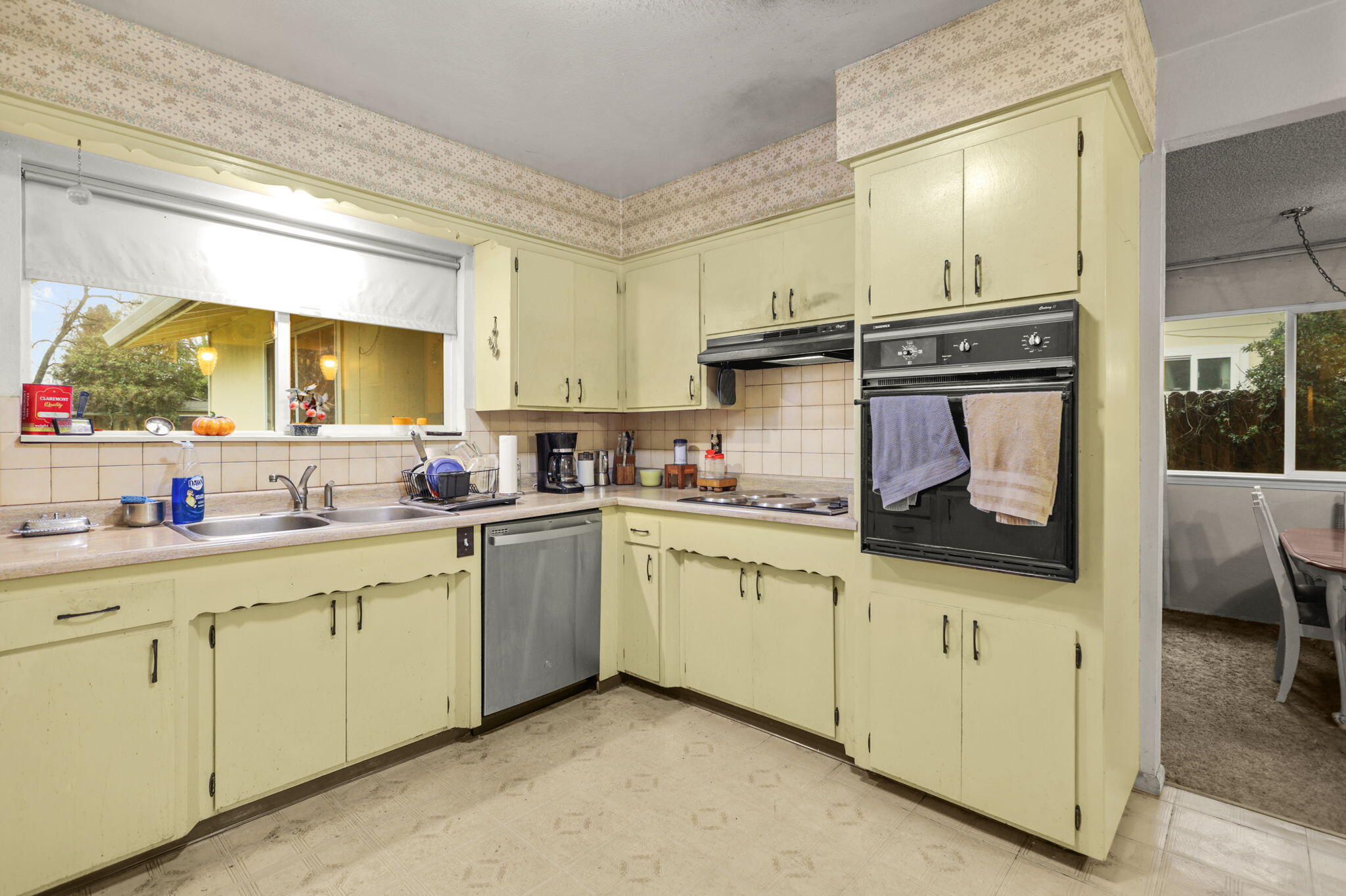 6725 Reflection Street Redding, CA 96001 - Photo 9 of 20 a kitchen with stainless steel appliances a stove microwave and cabinets