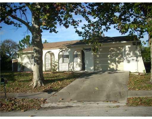 8759 Hemlock Lane Port Richey, FL 34668 - Photo 1 of 1 a view of a house with a yard