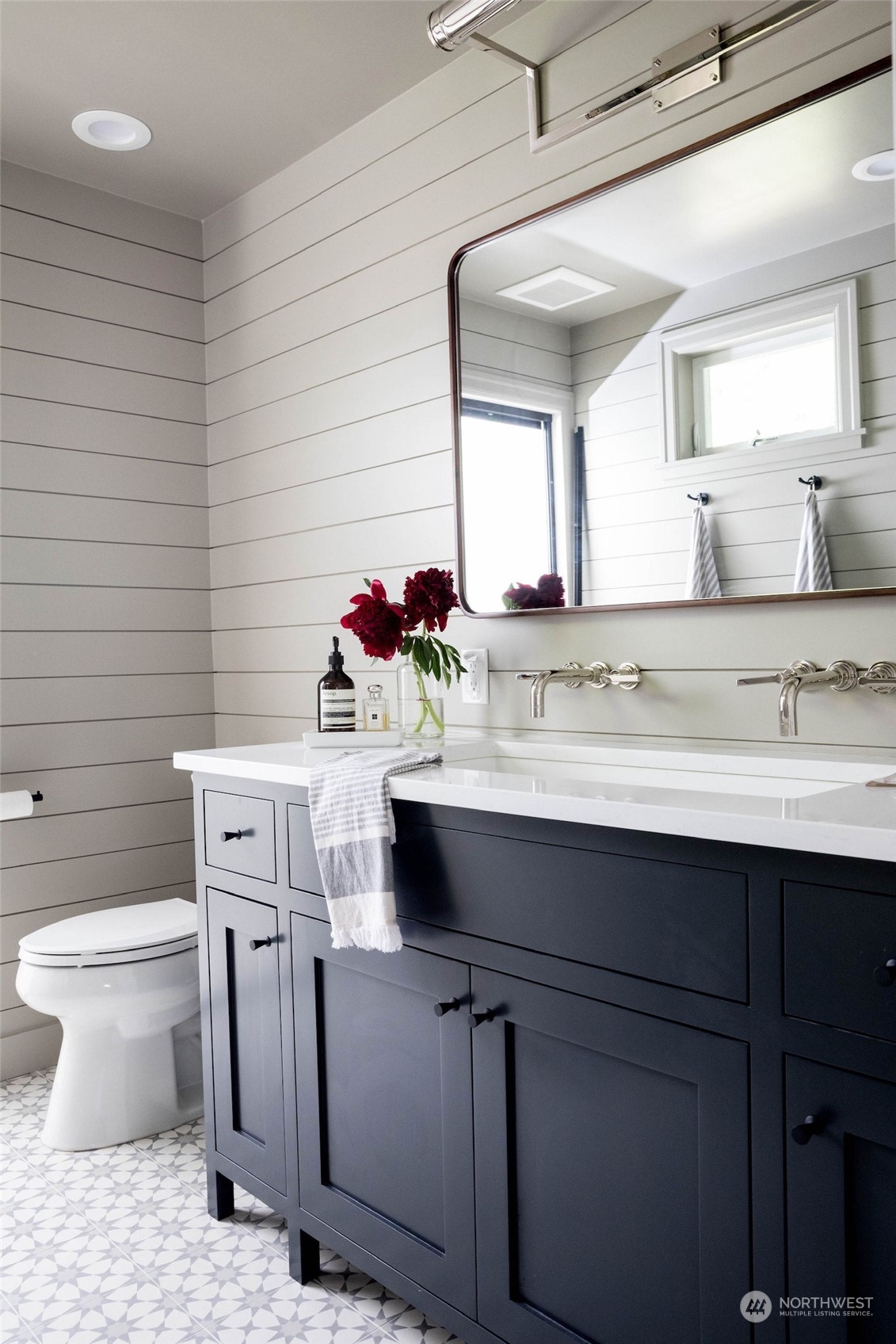 2114 North 65th Street Seattle, WA 98103 - Photo 18 of 40 a bathroom with a sink toilet and mirror