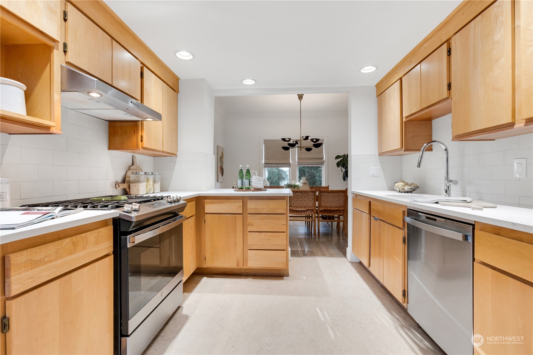 2114 North 65th Street Seattle, WA 98103 - Photo 20 of 40 a kitchen with stainless steel appliances granite countertop a sink stove and refrigerator