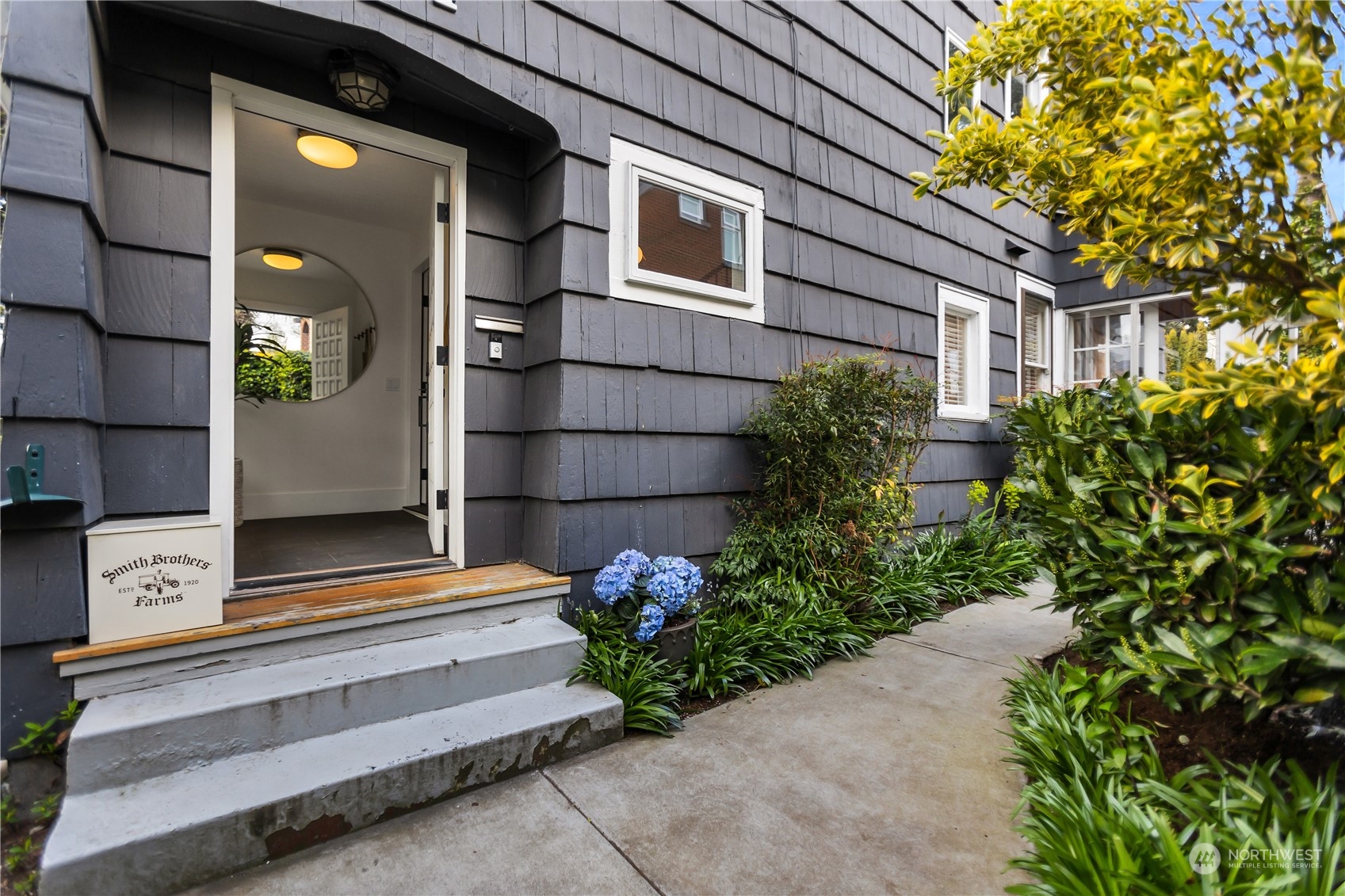 2114 North 65th Street Seattle, WA 98103 - Photo 2 of 40 a front view of a house with a garden