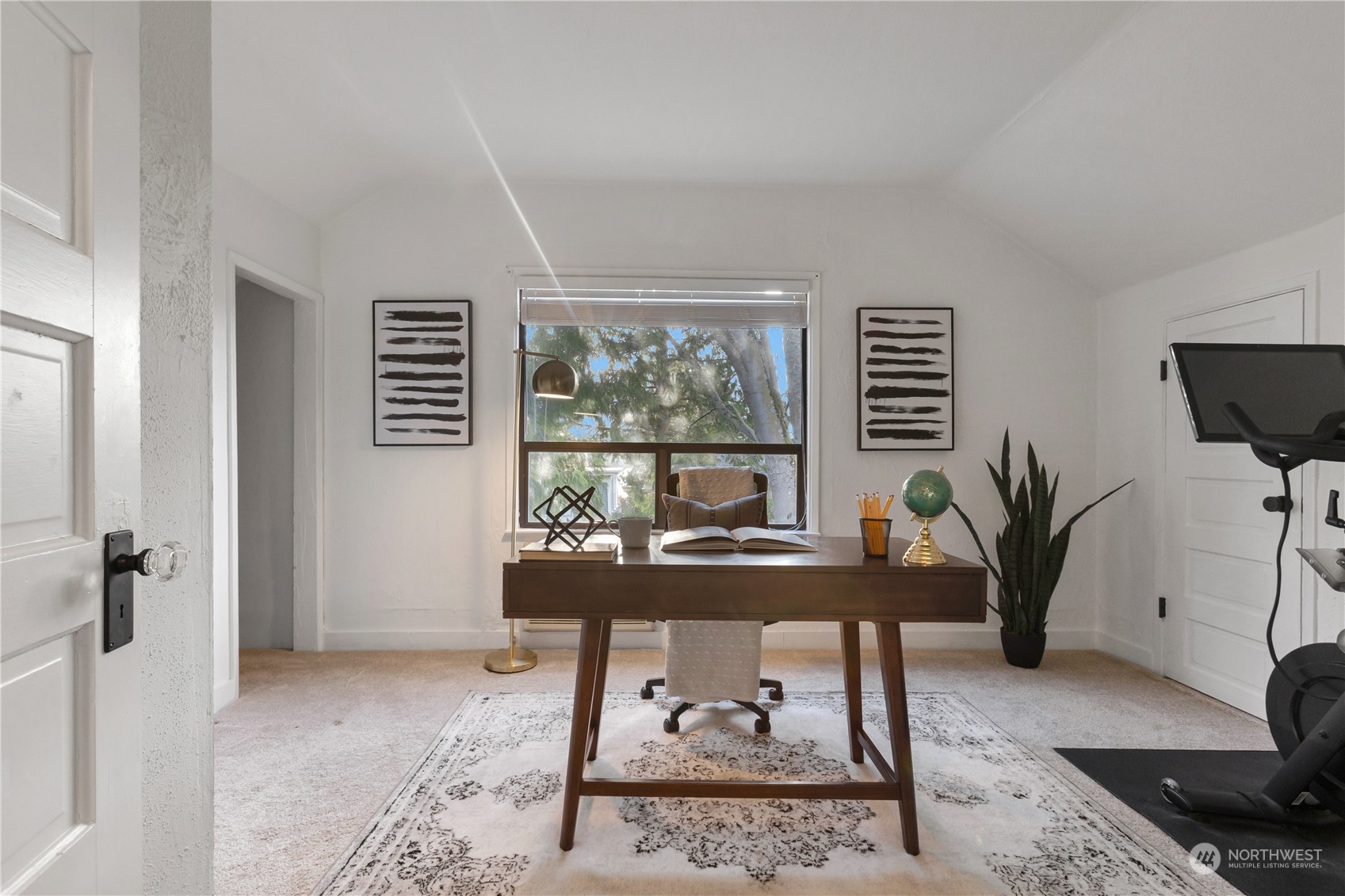 2114 North 65th Street Seattle, WA 98103 - Photo 23 of 40 a view of a workspace with furniture and a potted plant