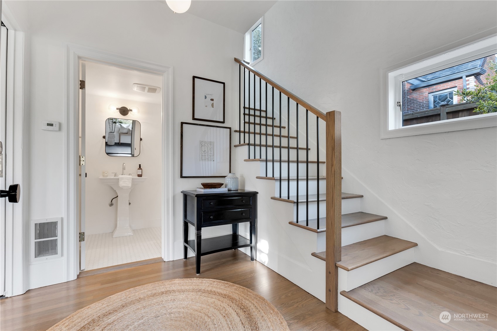 2114 North 65th Street Seattle, WA 98103 - Photo 4 of 40 a view of a livingroom with wooden floor and a staircase