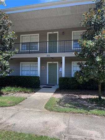 a front view of a house with a yard and a garage