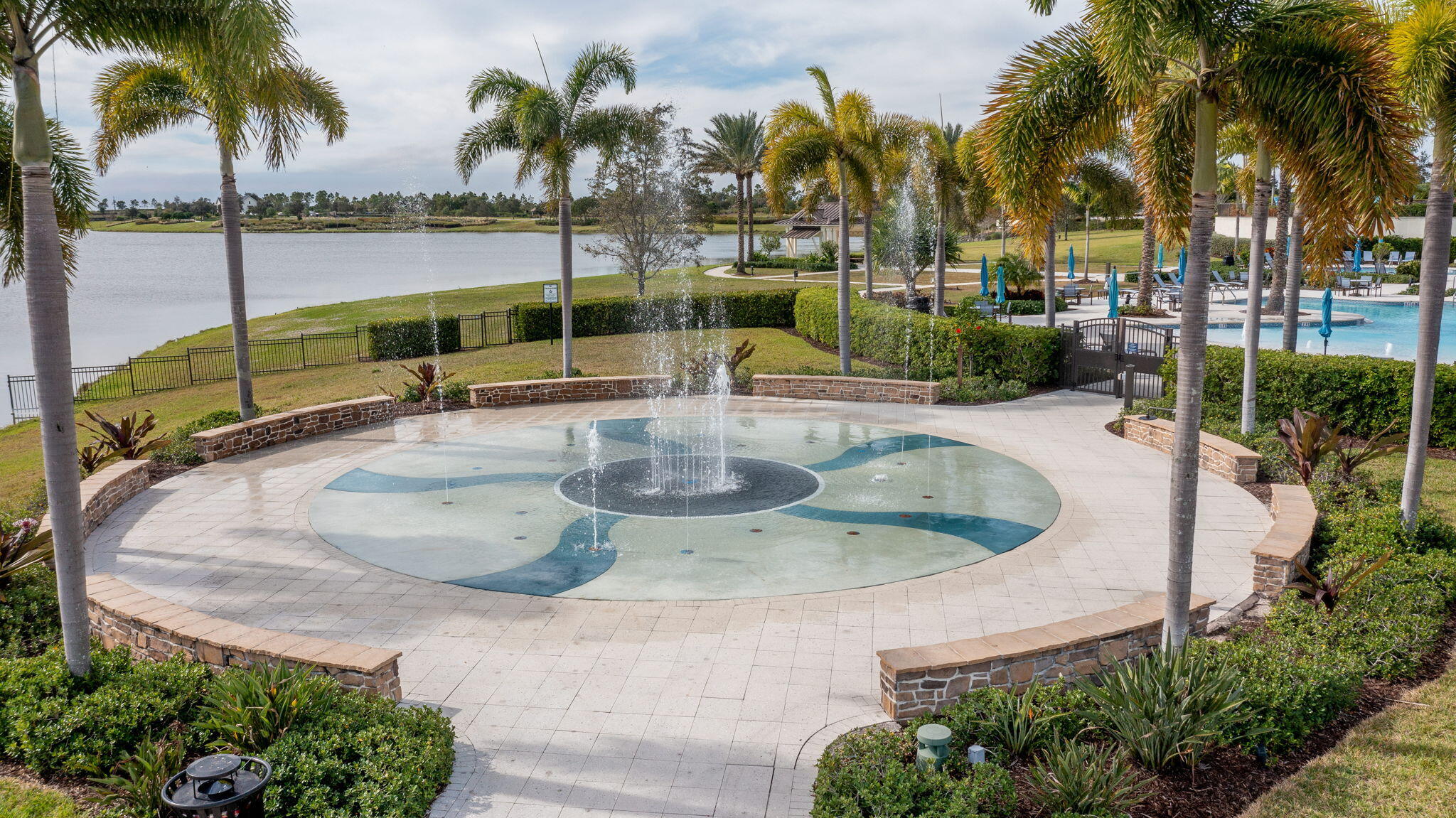 19546 Weathervane Way Loxahatchee, FL 33470 - Photo 52 of 63 a view of a swimming pool with a lawn chairs and palm tree