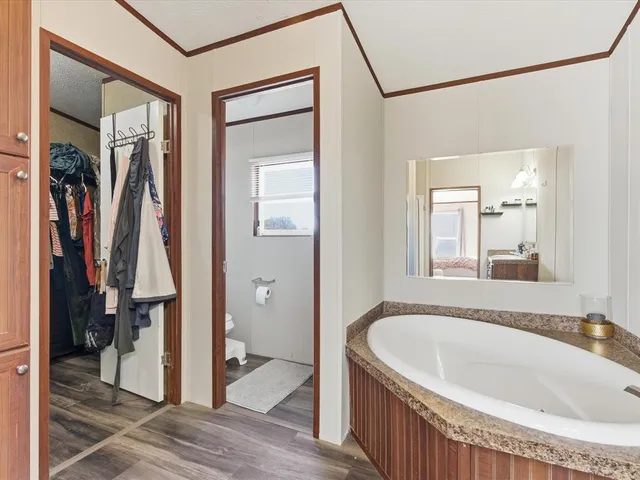 a spacious bathroom with a double vanity sink a mirror and a shower