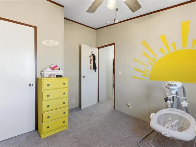 a bathroom with a granite countertop sink a toilet a shower and a mirror