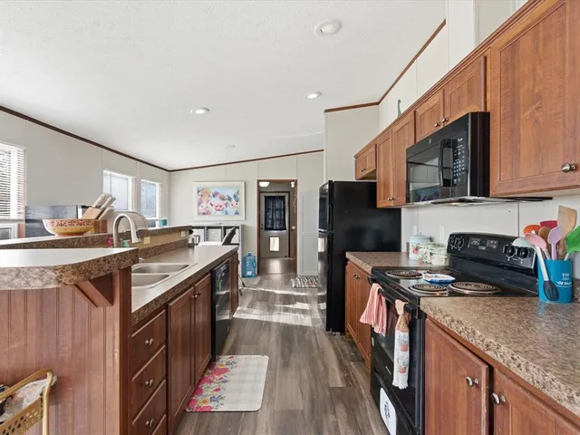 a kitchen with stainless steel appliances granite countertop a stove sink and cabinets