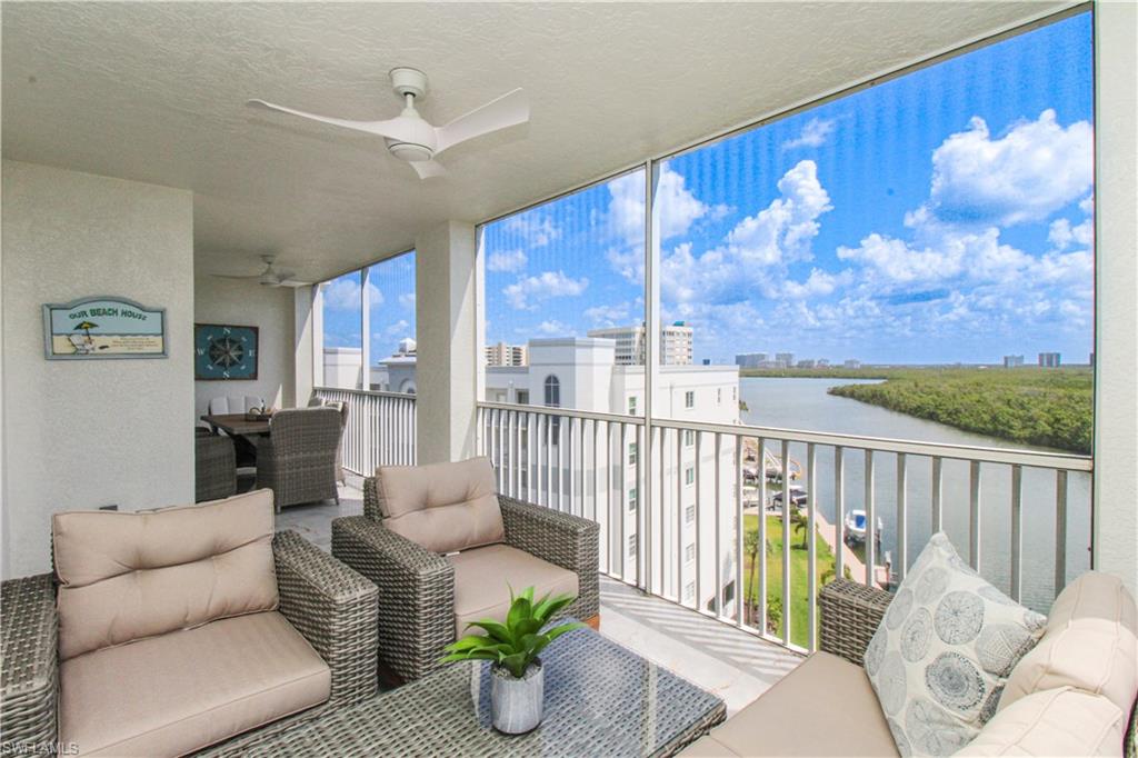 35 Bluebill Avenue, Unit B702 Naples, FL 34108 - Photo 11 of 50 a living room with furniture and a large window