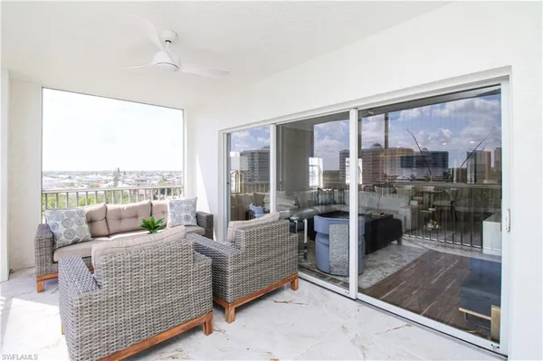 a living room with furniture and a floor to ceiling window