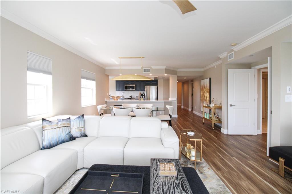 35 Bluebill Avenue, Unit B702 Naples, FL 34108 - Photo 19 of 50 a living room with furniture and a large window