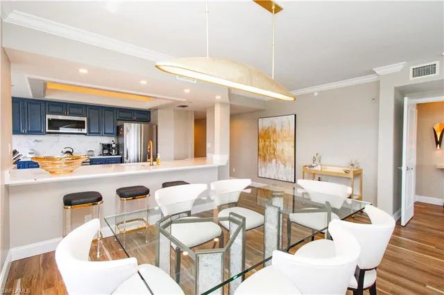 a living room with kitchen island furniture and a kitchen view