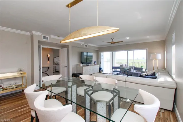 a dining room with furniture and a large window