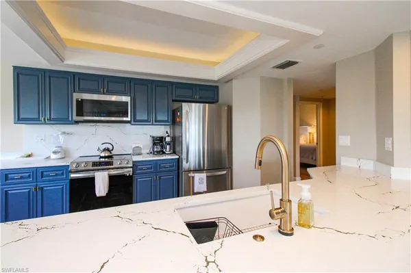 a kitchen with kitchen island a sink appliances and cabinets