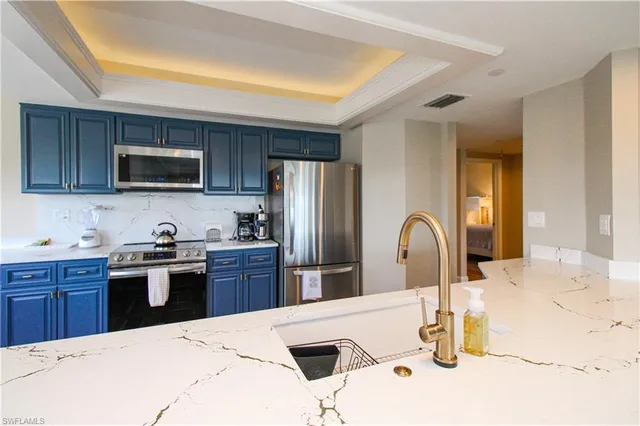a kitchen with kitchen island a sink appliances and cabinets