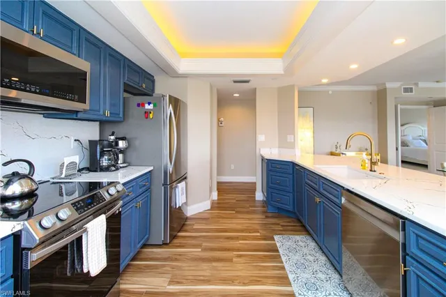 a large kitchen with stainless steel appliances granite countertop a stove a sink dishwasher and a microwave oven with cabinets