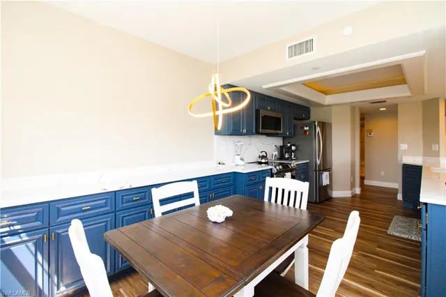a kitchen with a table chairs and a dining table