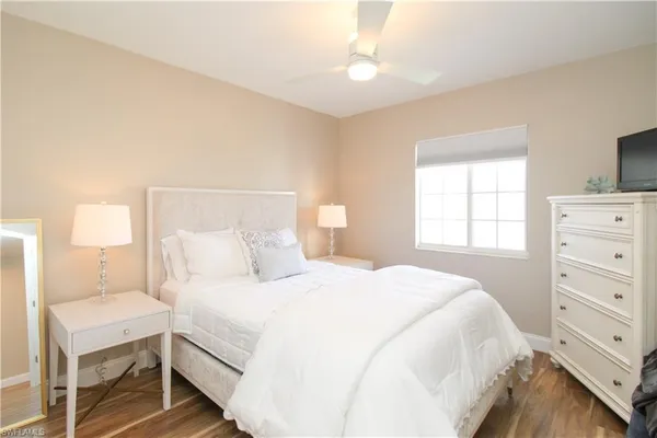 a bedroom with a bed and a dresser in it