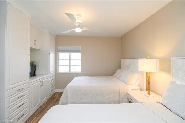 a bedroom with a bed and a lamp on dresser