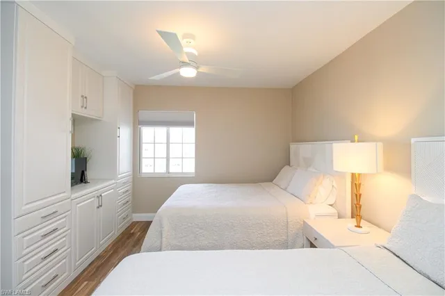 a bedroom with a bed and a lamp on dresser