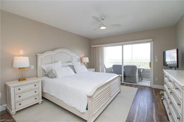 a bedroom with a bed and a flat tv screen on a dresser