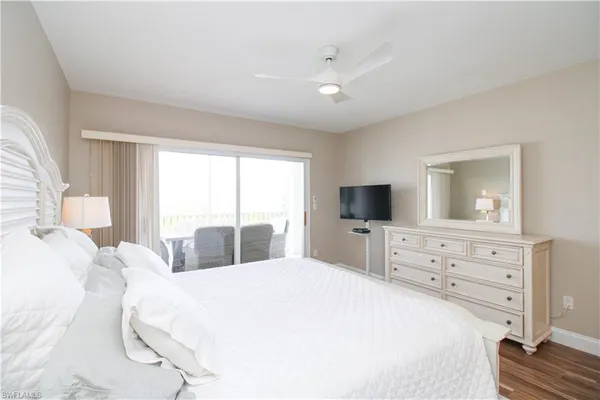 a bedroom with a large bed and a flat screen tv