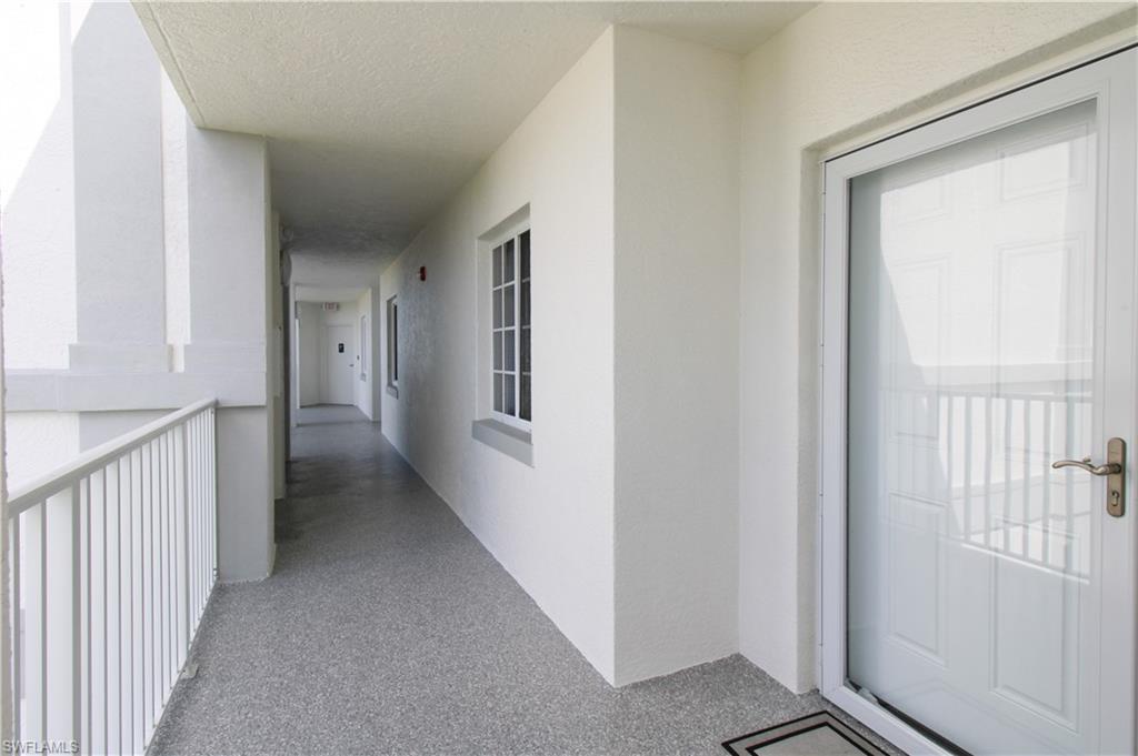 35 Bluebill Avenue, Unit B702 Naples, FL 34108 - Photo 6 of 50 a view of a hallway with a room that has a window