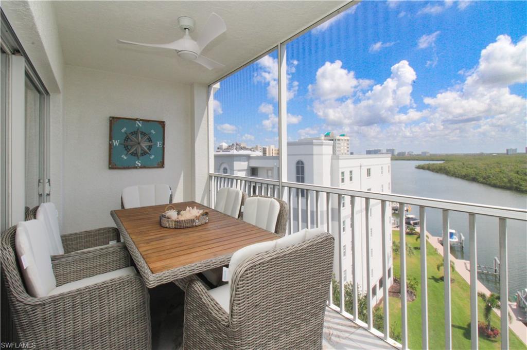 35 Bluebill Avenue, Unit B702 Naples, FL 34108 - Photo 9 of 50 a view of a balcony furniture and floor to ceiling window