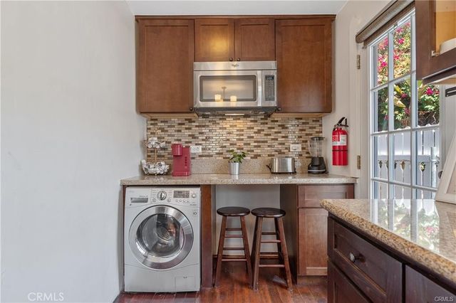 a kitchen with stainless steel appliances granite countertop a sink and cabinets
