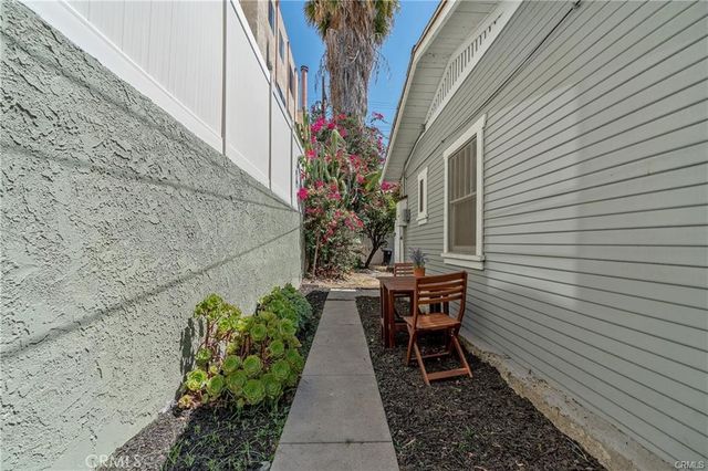 a view of a patio with table and chairs and potted plants