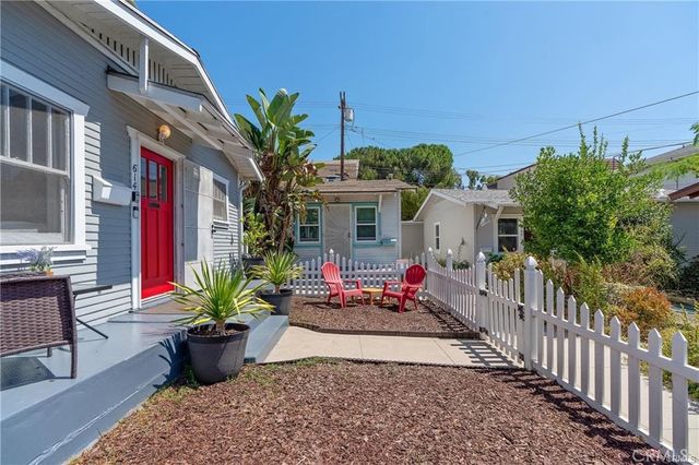 a front view of house with yard outdoor seating and barbeque oven