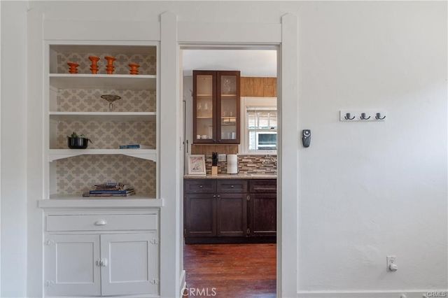 a bathroom with a granite countertop sink and a window